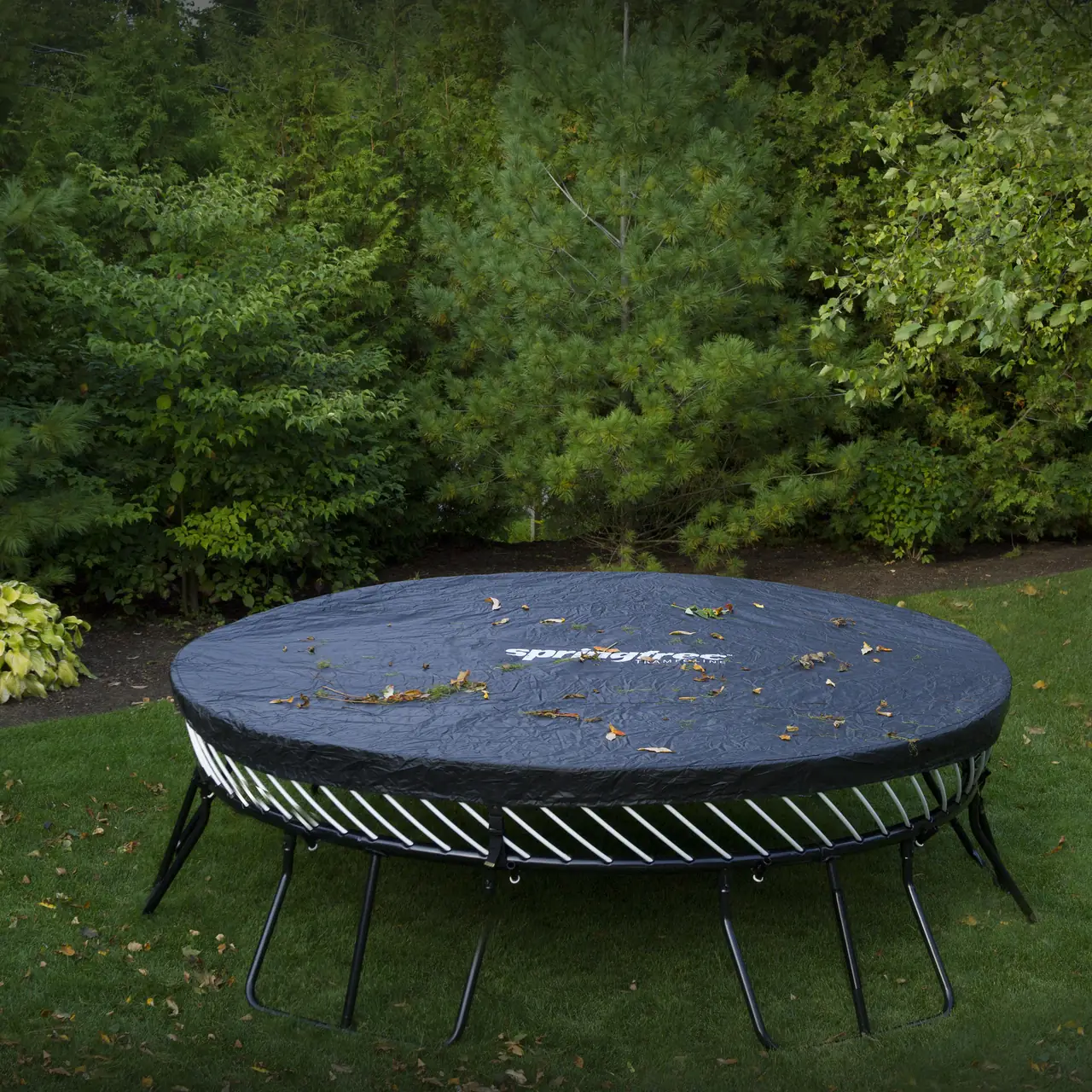 Trampolína Springfree s krycí plachtou na zahradě